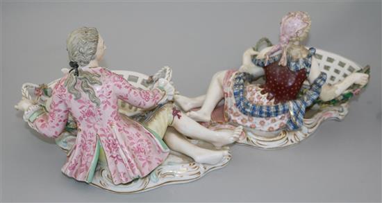 A pair of English porcelain figural sweetmeat dishes, mid 19th century, after the Meissen originals, length 29cm, restorations